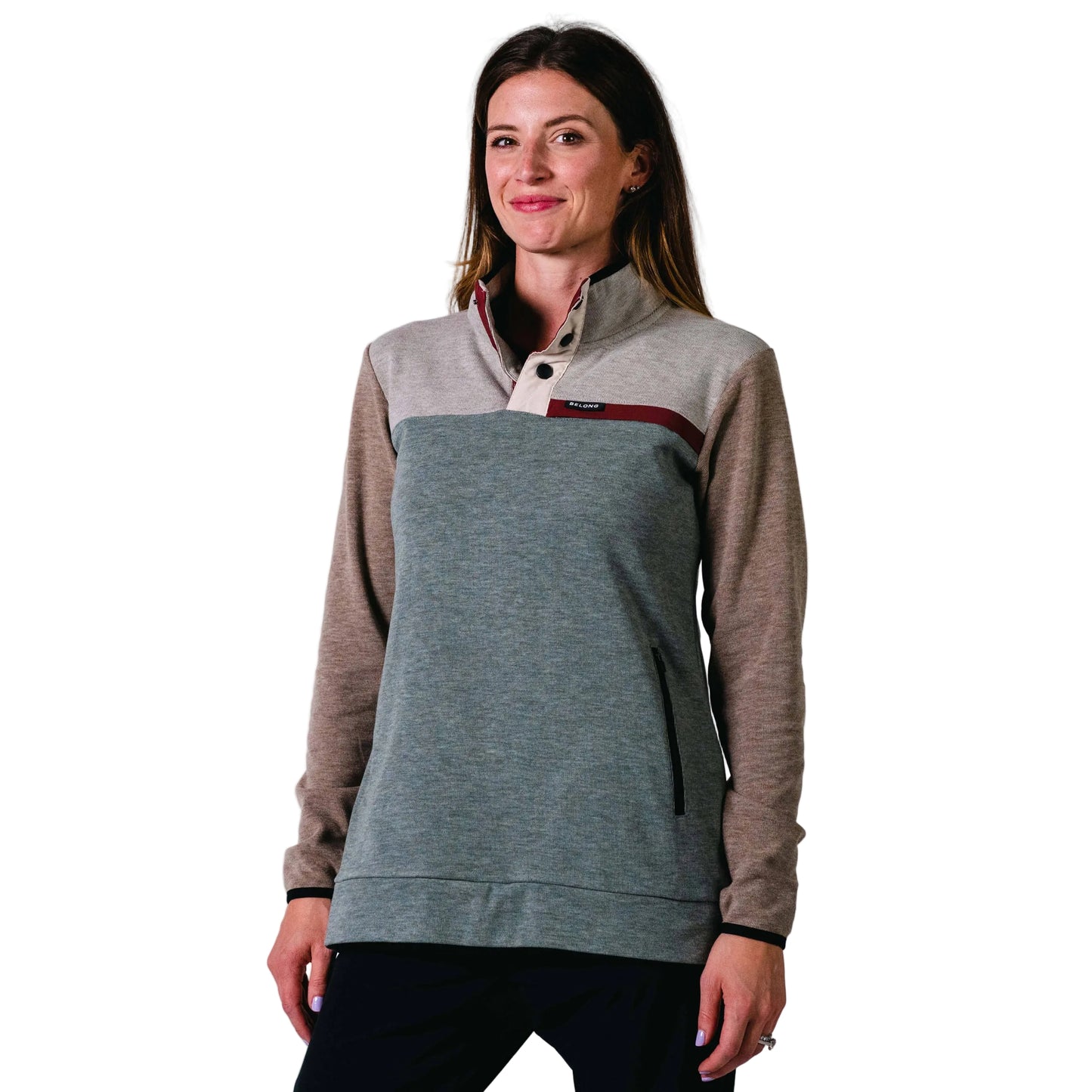 Woman wearing an aqua and brown pullover against a white background
