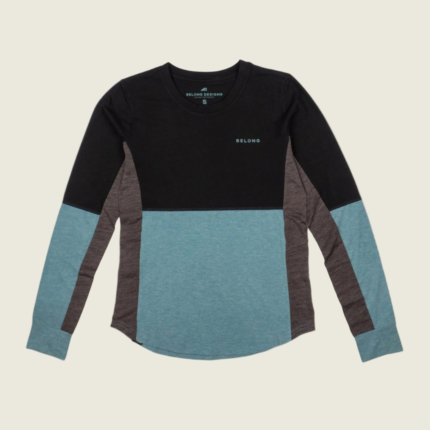 Color-blocked long-sleeve shirt with black, blue, and gray sleeves on a beige background