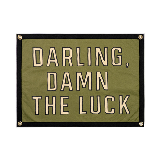 Green banner with text 'Darling, damn the luck' on a white background